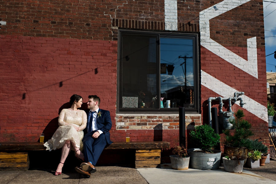 A newly married couple share a beer outside of their wedding venue in south Philadelphia.